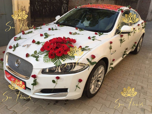 “Elegant wedding car decoration with red roses and gerberas by Sai Flower Delhi NCR. Luxury bridal car floral décor for weddings and receptions.”