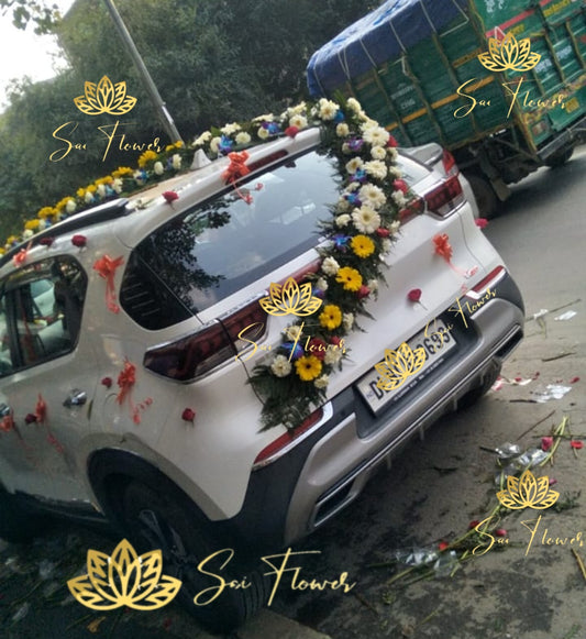 “Full wedding car decoration with fresh mixed flowers including roses, gerberas & orchids by Sai Flower in Delhi NCR.”