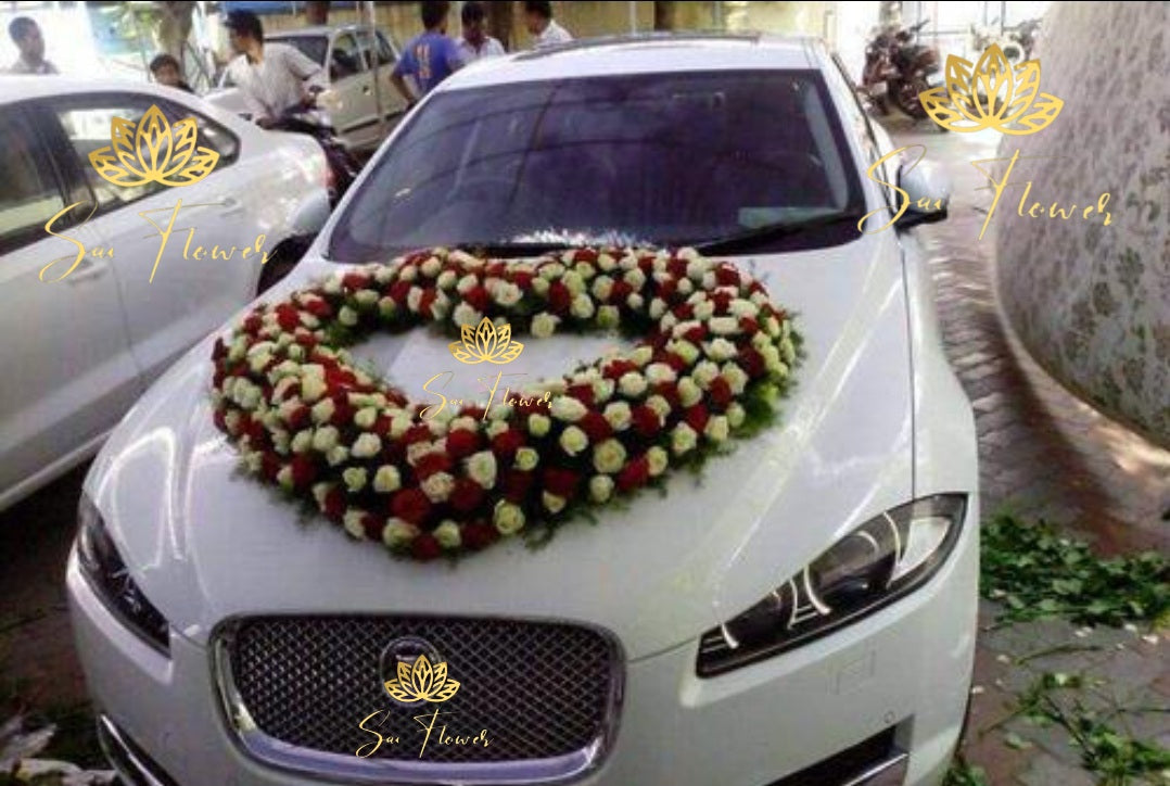 “Heart-shaped red and white rose wedding car decoration by Sai Flower Delhi NCR. Romantic car floral décor for weddings and anniversaries.”