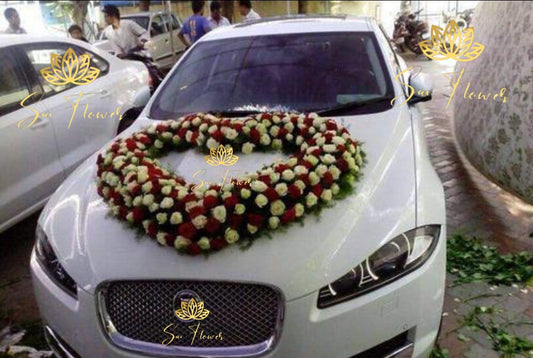 “Heart-shaped red and white rose wedding car decoration by Sai Flower Delhi NCR. Romantic car floral décor for weddings and anniversaries.”