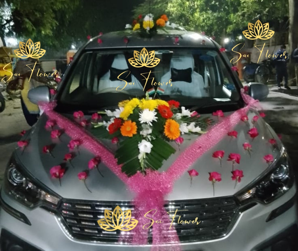 “Elegant wedding car decoration with fresh roses, gerberas, and pink ribbon by Sai Flower Delhi NCR.”