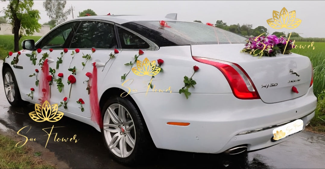 “Luxury wedding car decoration with red roses and orchids on a white Jaguar by Sai Flower Delhi NCR.”