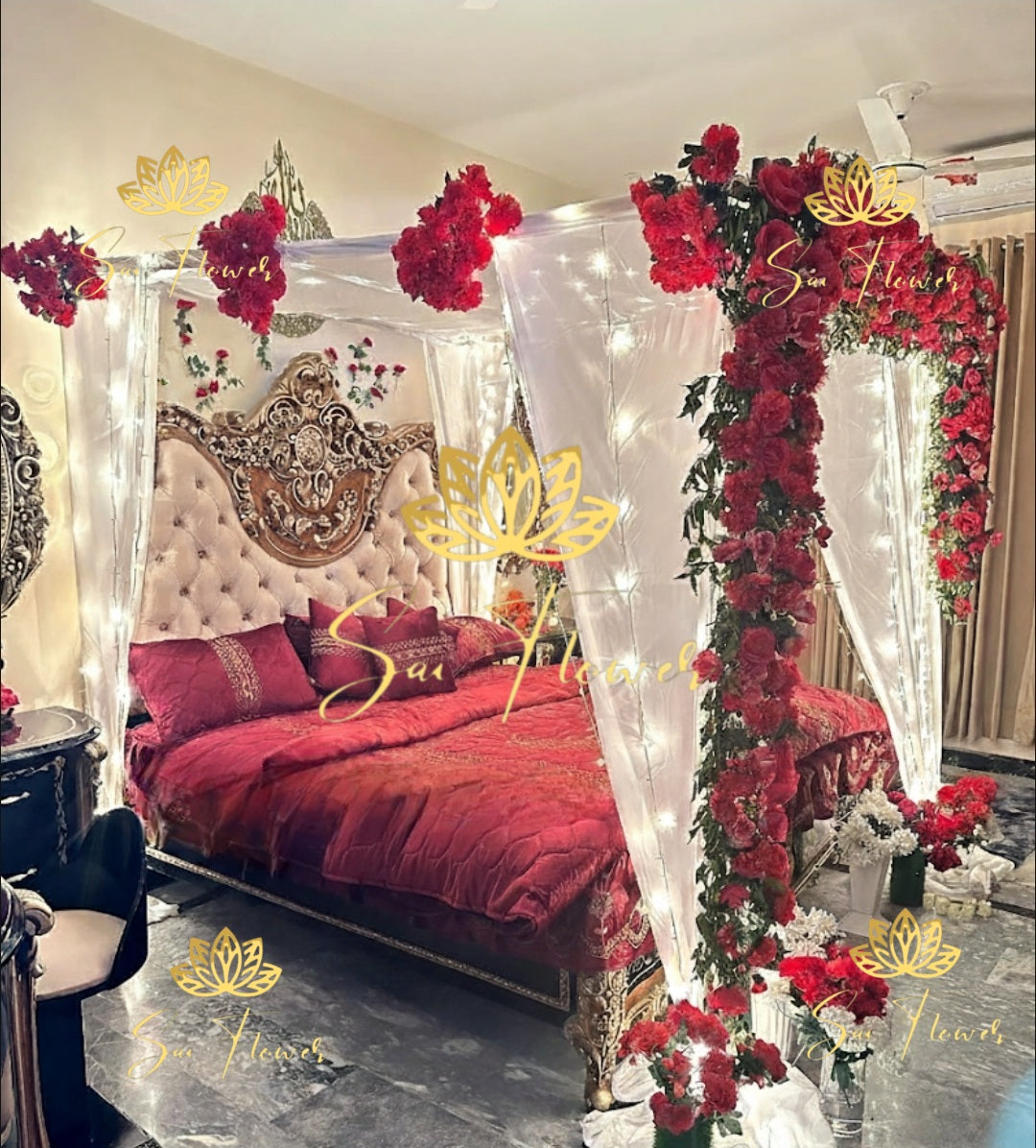 “Royal red rose and LED canopy fresh flower bed decoration with white drapes and lights by SaiFlower for wedding and anniversary setups”